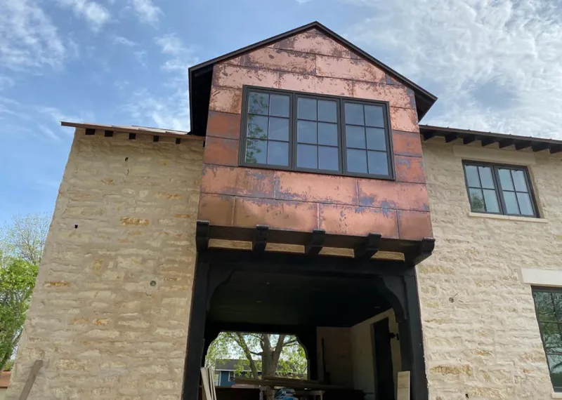 Copper metal panel facade on a stone building for Skylight Installation in Plain City