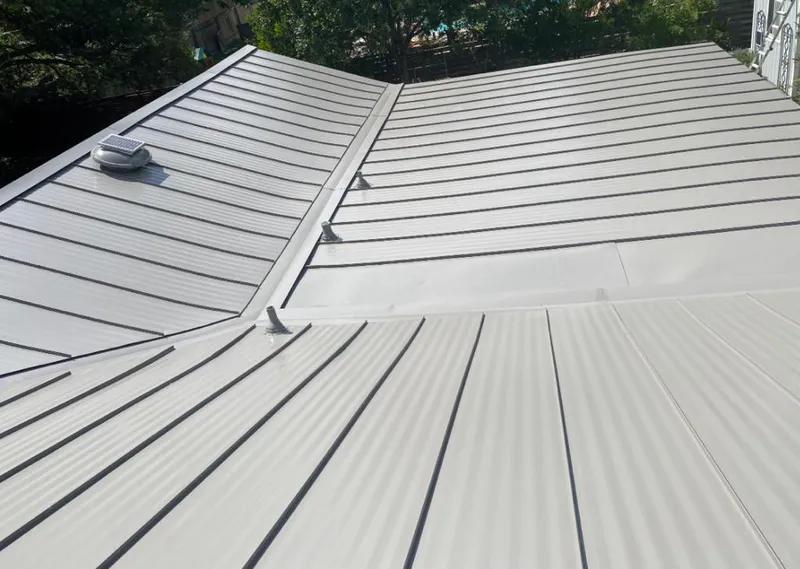 Solar attic fan installed on a metal roof for Roof Ventilation in Plain City